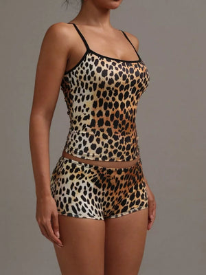 Women's leopard print cami and shorts pajama set with black trim.