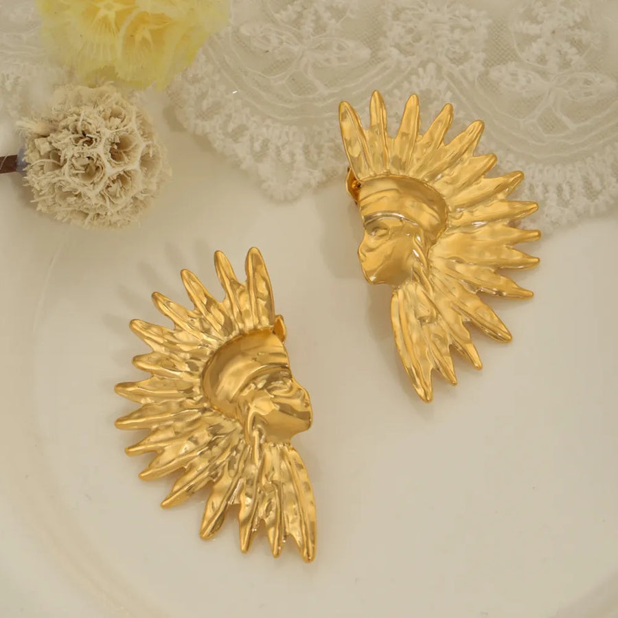 Gold sculptural face earrings with sunburst detail