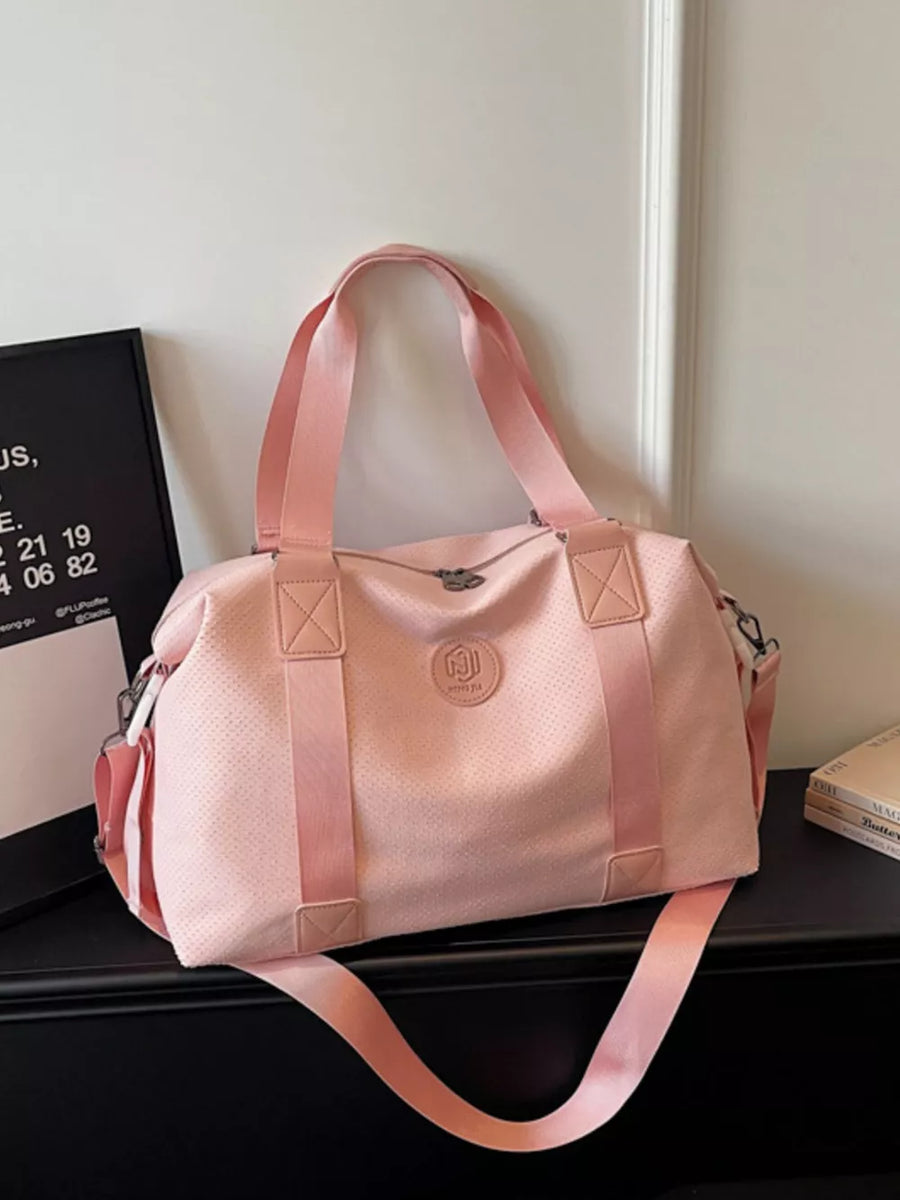 Pink perforated large duffle bag with dual handles and crossbody strap