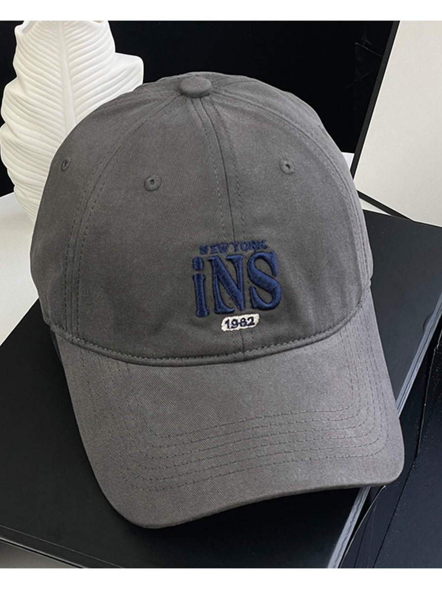 Grey baseball cap with embroidered INS New York 1982 detail