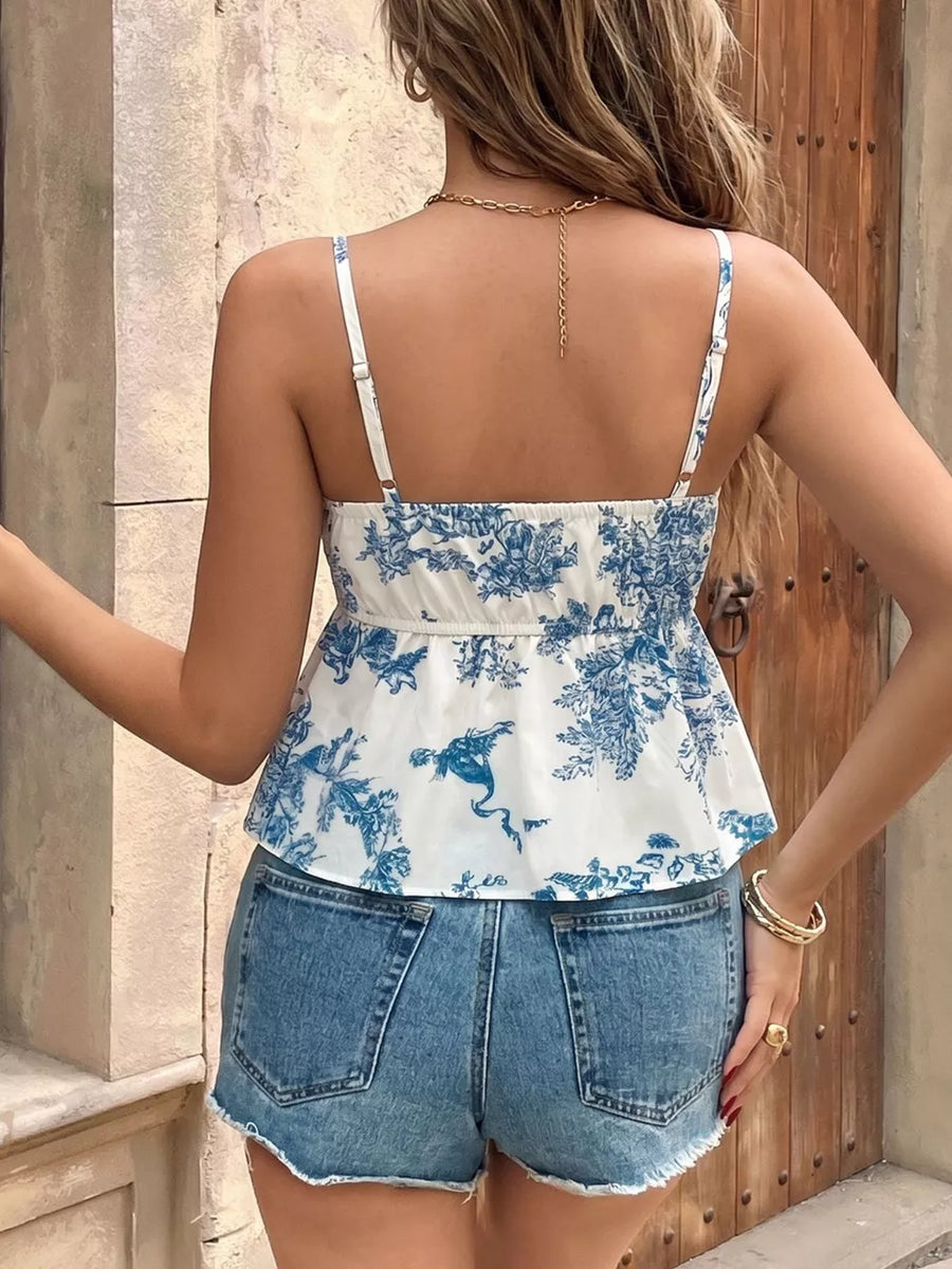 White and blue floral tie-front cami top with adjustable straps and smocked back detail.