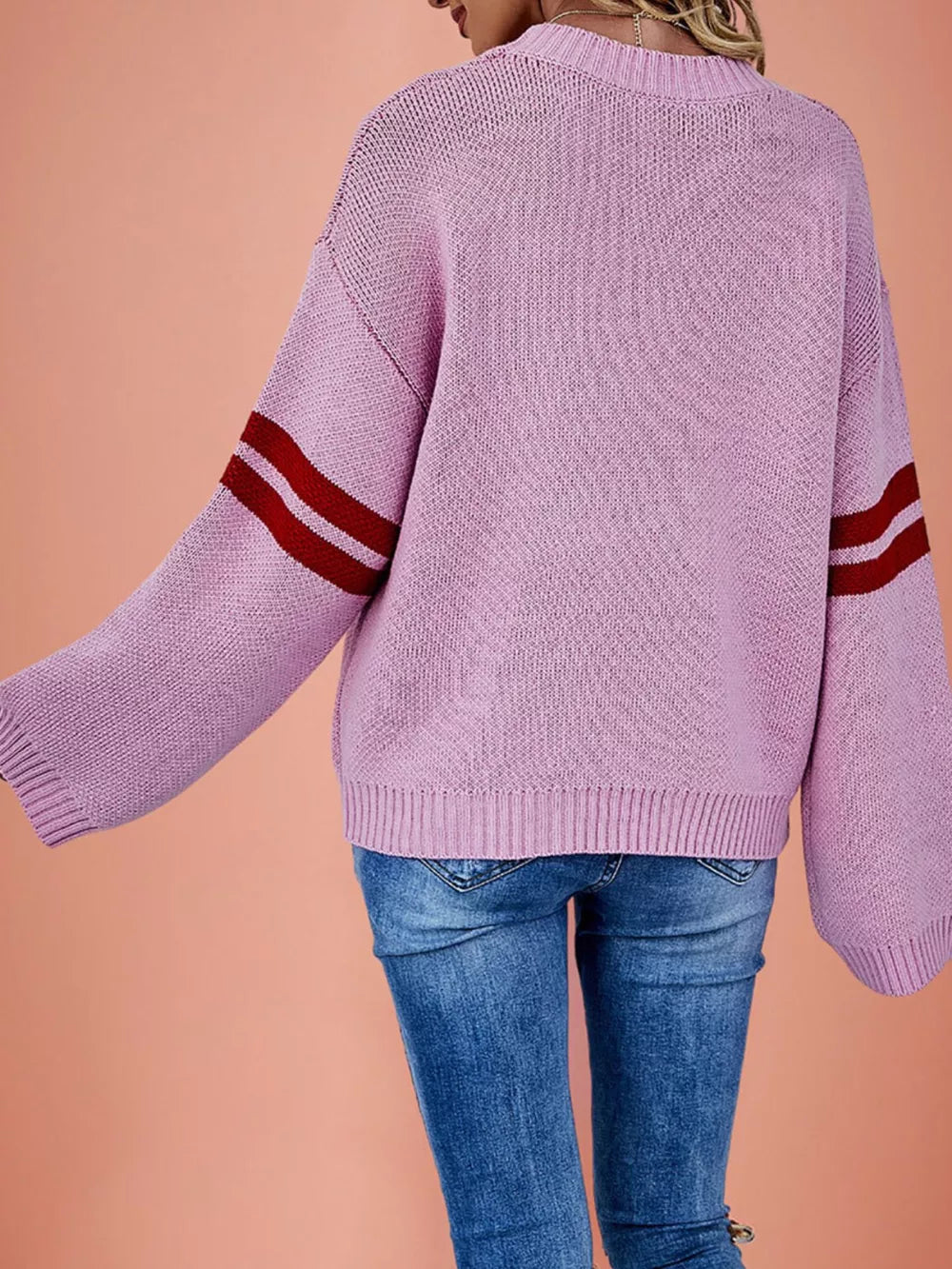 red pullover sweater featuring ribbed cuffs and heart-print