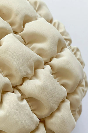 Ivory padded crescent crossbody bag with sculptural texture detail