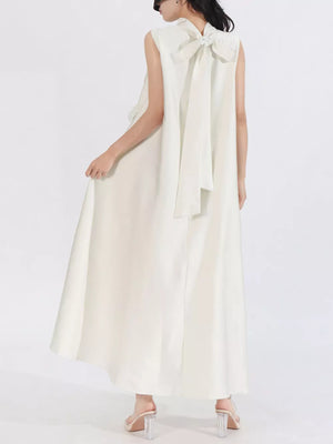 White sleeveless maxi dress with a large bow detail at the back neckline.