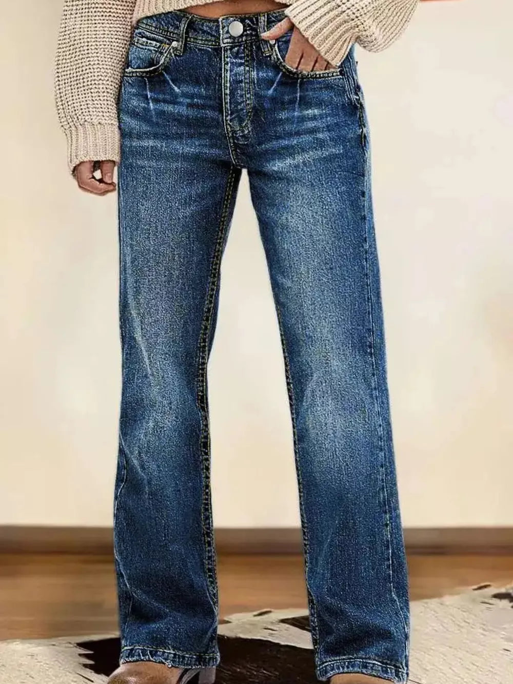 Dark blue vintage wash straight leg denim jeans with button fly and whiskering details.