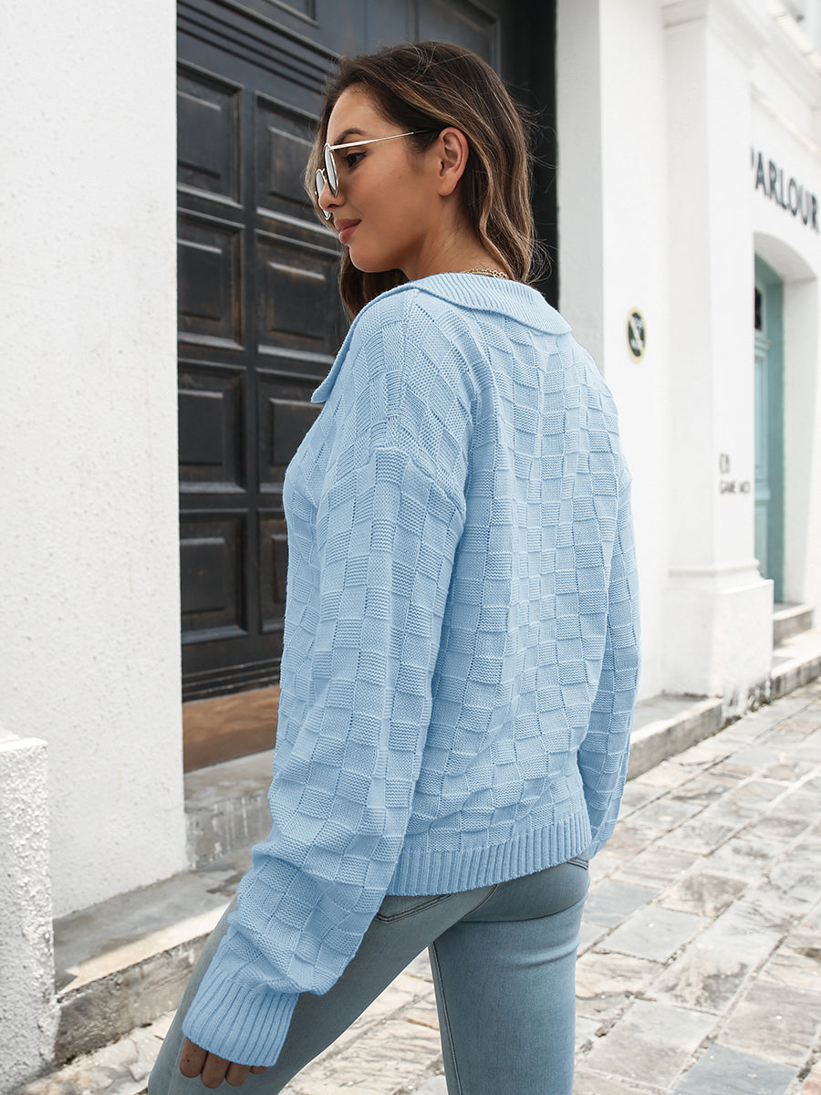 Light blue acrylic knit sweater with textured checkerboard pattern and polo neckline.