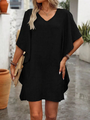 Black V-neck mini dress with flowy sleeves and a relaxed fit.