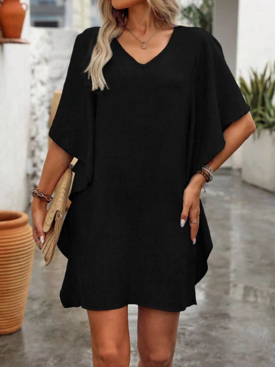 Black V-neck mini dress with flowy sleeves and a relaxed fit.