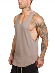 Mocha scoop neck muscle tank top with a curved hem and side slits.