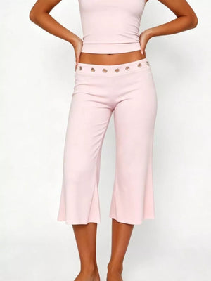 Pink maternity capri pants with flared hem and button detail at waist