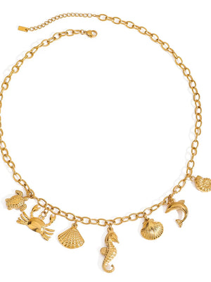 Gold necklace featuring multiple marine-inspired pendants and geometric