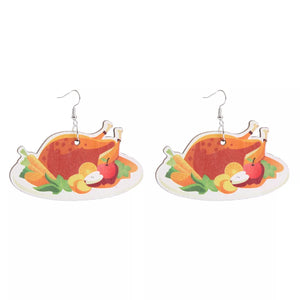 Dangle earrings featuring a roasted turkey dinner with carrots and apples on a white platter.
