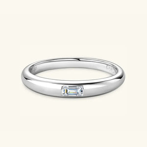 Silver band ring with a single rectangular moissanite gemstone.