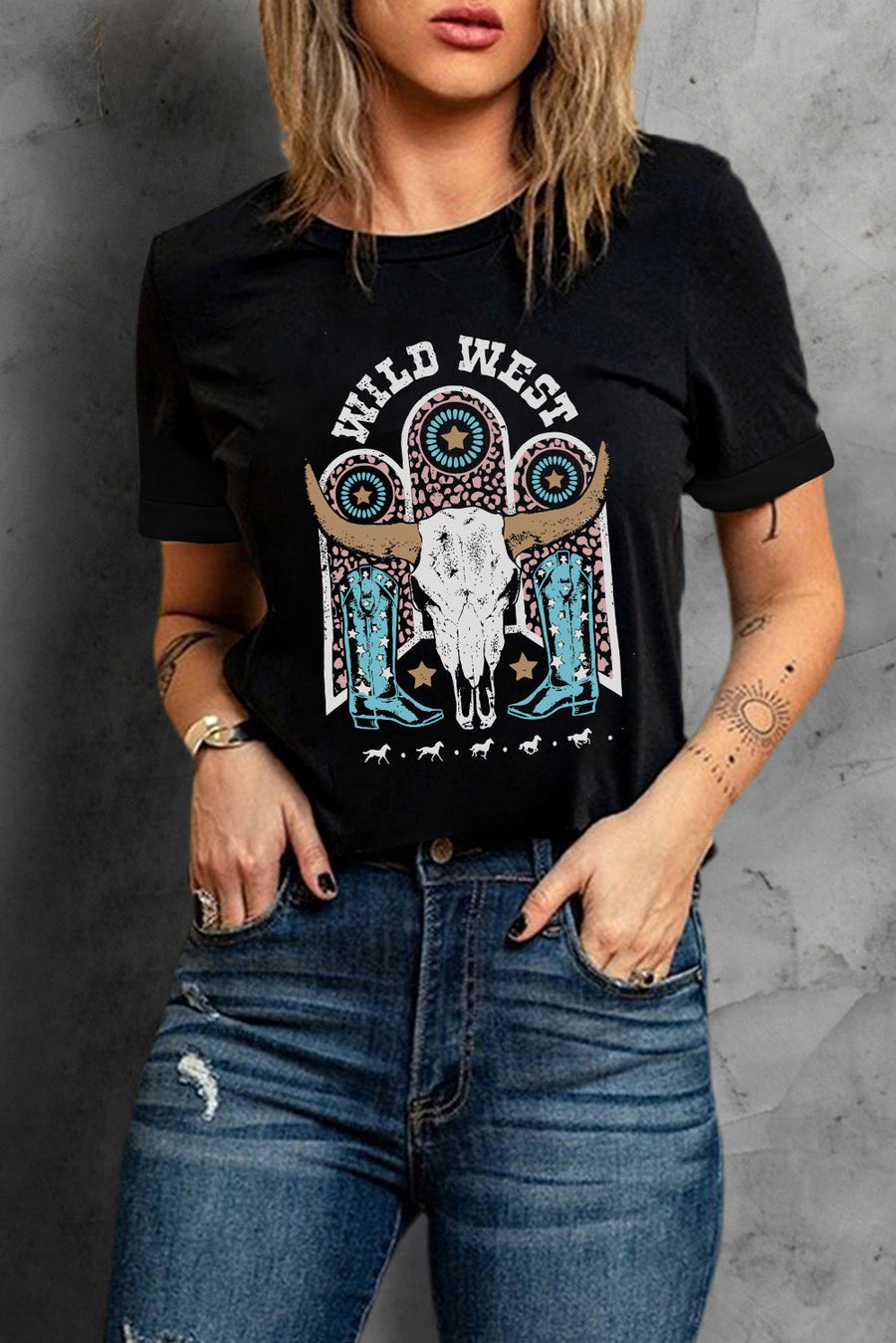 Black crewneck tee with a Wild West graphic featuring a bull skull, cowboy boots, and horses.