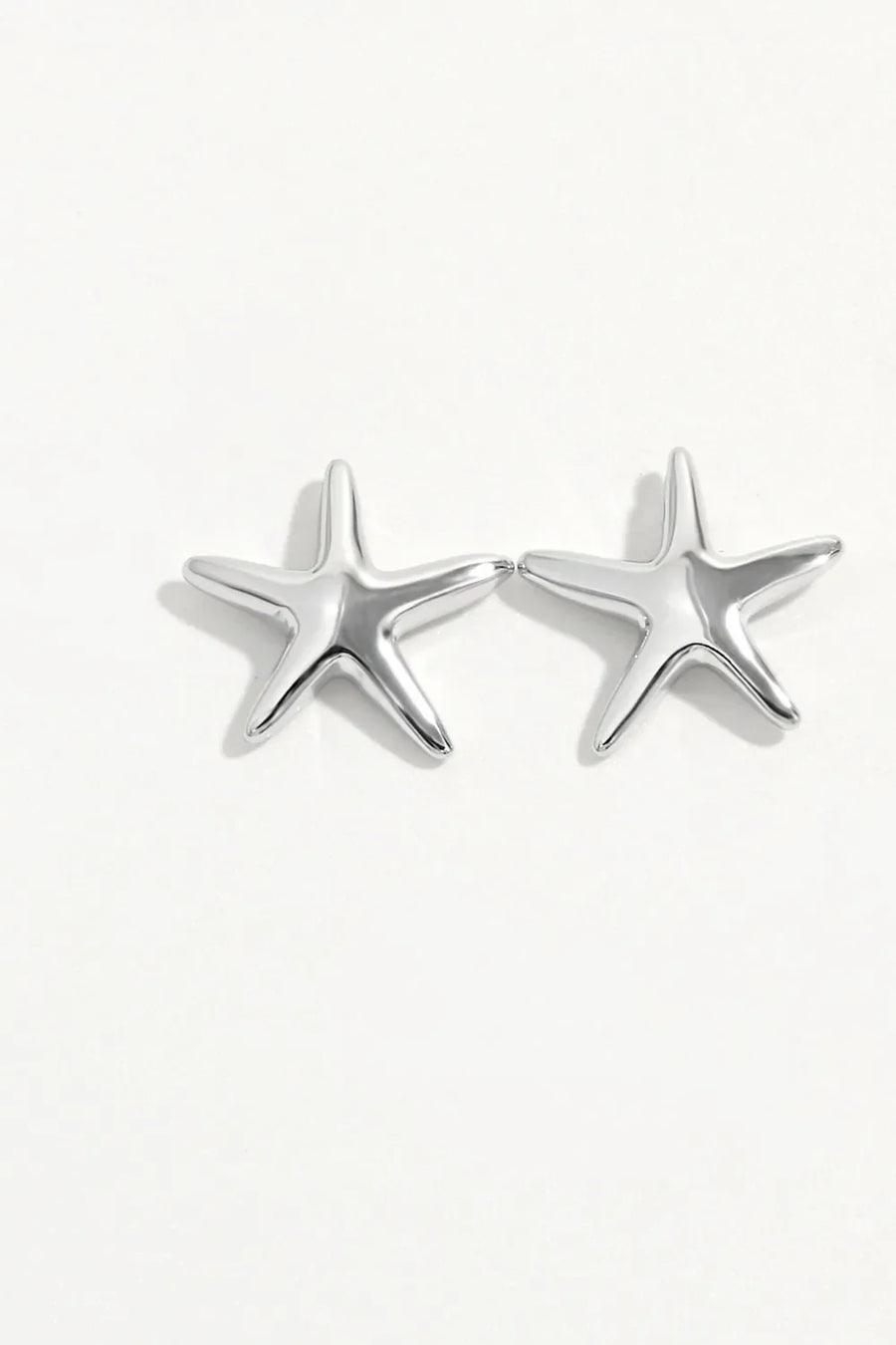 Sculpted silver starfish stud earrings with a polished finish.