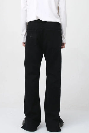Flared hem denim trousers in dark cotton with a subtle distressed detail on the back pocket.