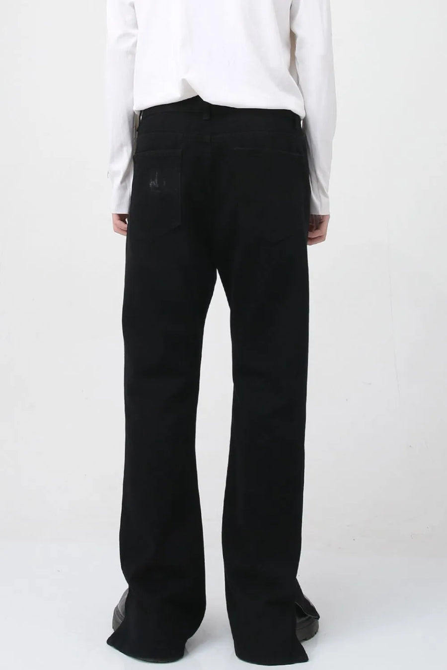 Flared hem denim trousers in dark cotton with a subtle distressed detail on the back pocket.