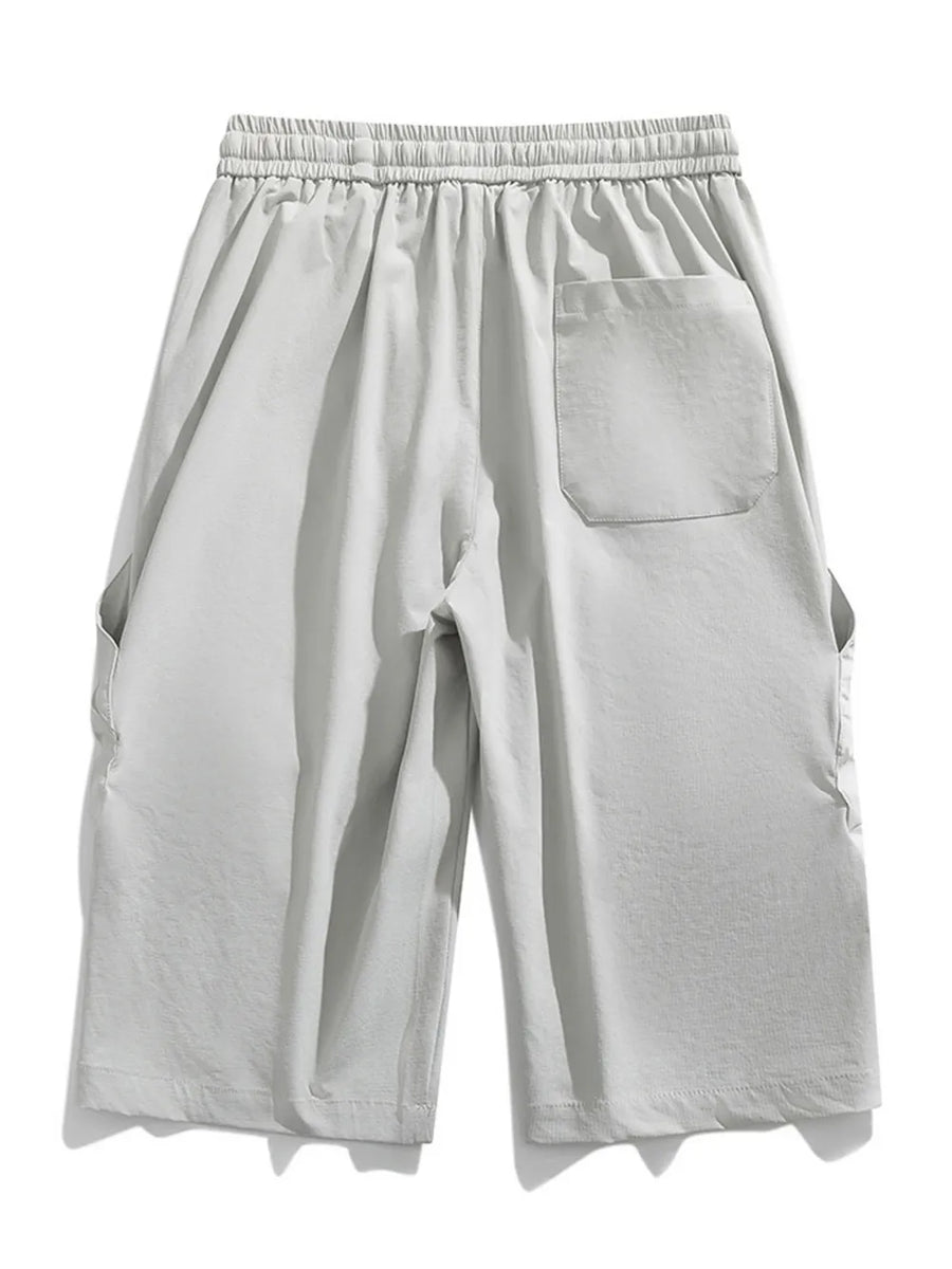 Men's light gray cargo capris with adjustable drawstring and back pocket.