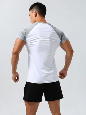 Raglan sleeve performance tee in white with gray sleeves, crew neck, and athletic fit.