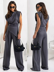 Gray satin cowl neck two-piece set with wide-leg pants and padded shoulders.