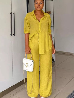 Lemon yellow tie-front collared shirt and wide-leg pants ensemble with a white handbag.