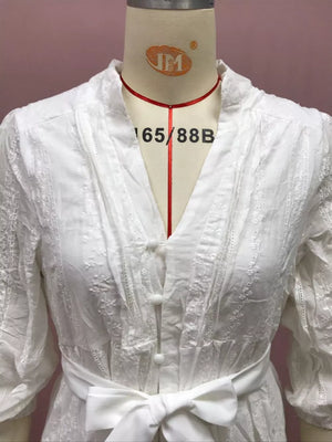 White embroidered cotton dress with stand collar, button front, and tie waist