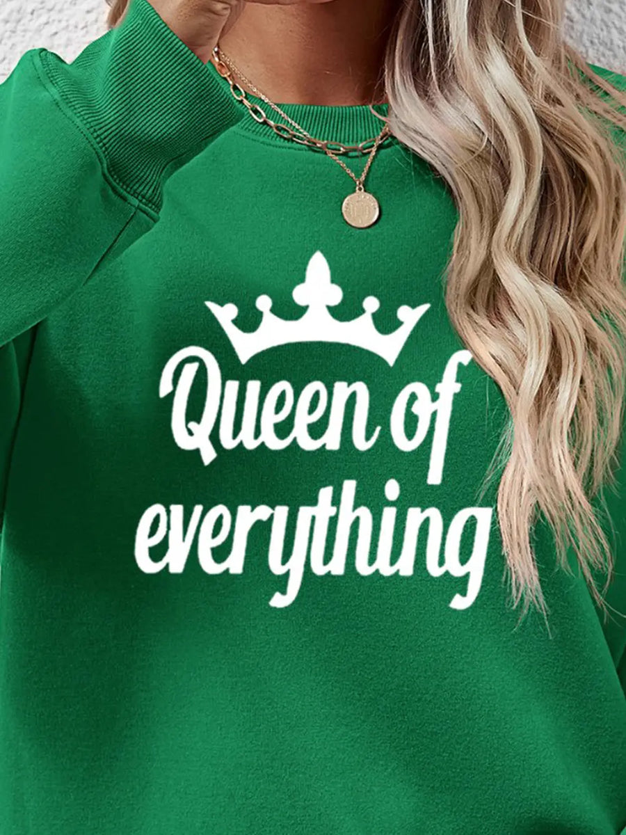 Green graphic sweatshirt with white Queen of Everything text and crown design.