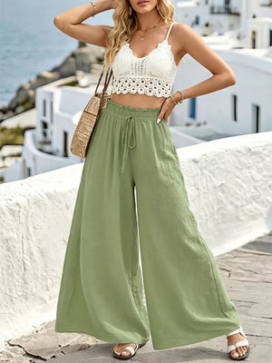 Green linen wide-leg pants with drawstring waist and ruffled hem