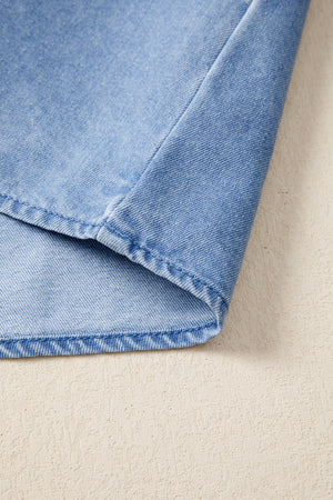 Light blue distressed denim top with visible stitching detail