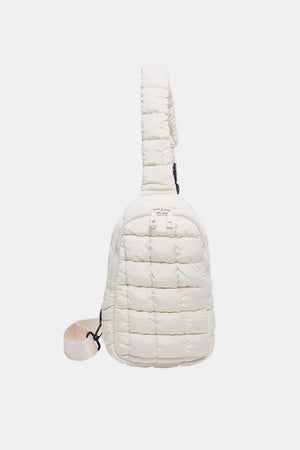 Padded sling bag in ivory with quilted texture and top handle