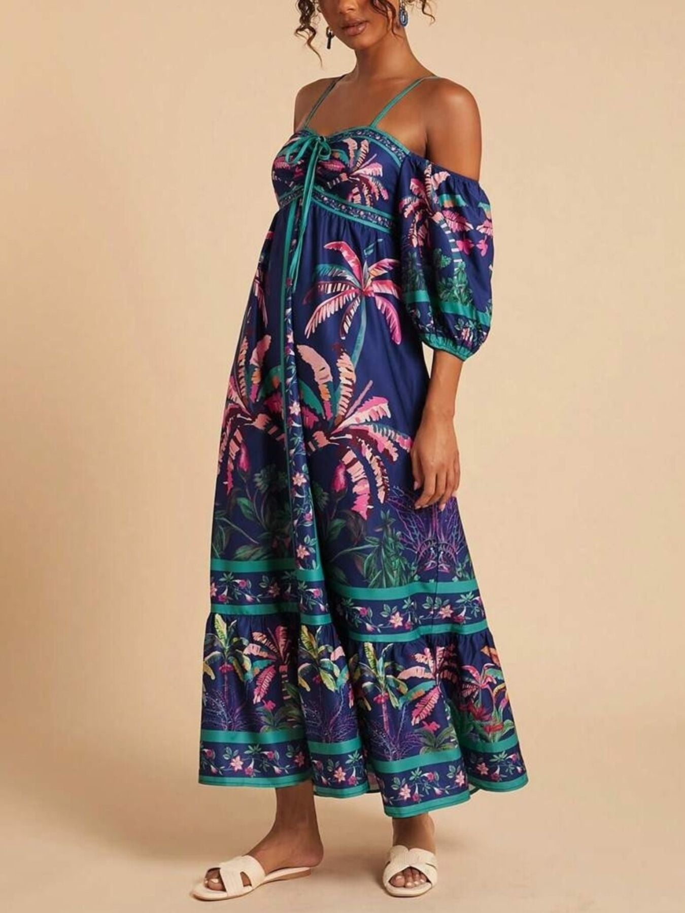 Maxi dress with tropical print, smocked bodice, cold shoulder sleeves, and tiered skirt.