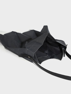 Black tote featuring pleated and geometric