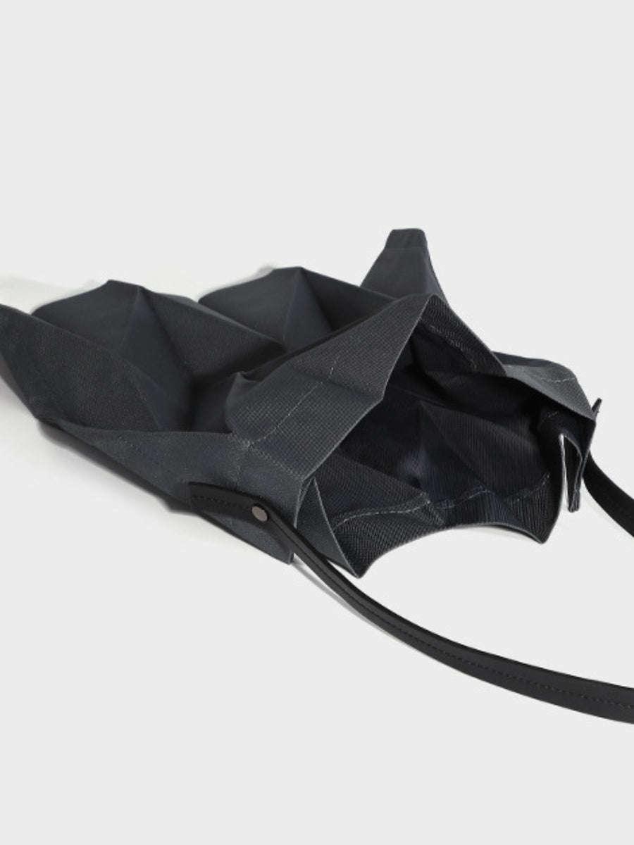 Black tote featuring pleated and geometric