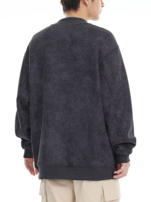 Dark gray oversized corduroy sweatshirt with round neck and ribbed cuffs and hem.