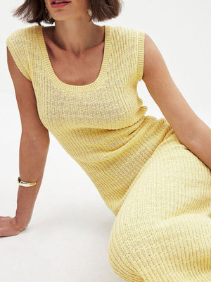 Yellow knit midi dress with scoop neck and side slit detail.