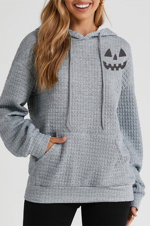 Charcoal waffle knit hoodie with jack-o-lantern graphic and front pocket.