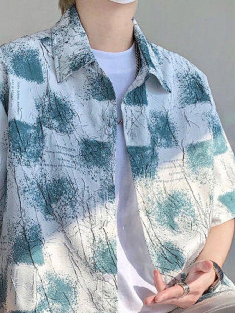 Men's abstract print short sleeve button-down shirt in white with teal accents.