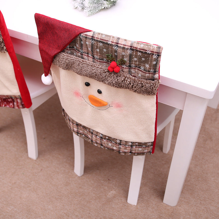 Snowman chair cover with red Santa hat, plaid trim, and berry accents.
