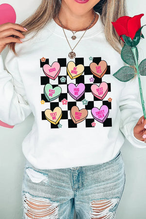 White sweatshirt with conversation heart graphic and checkered background