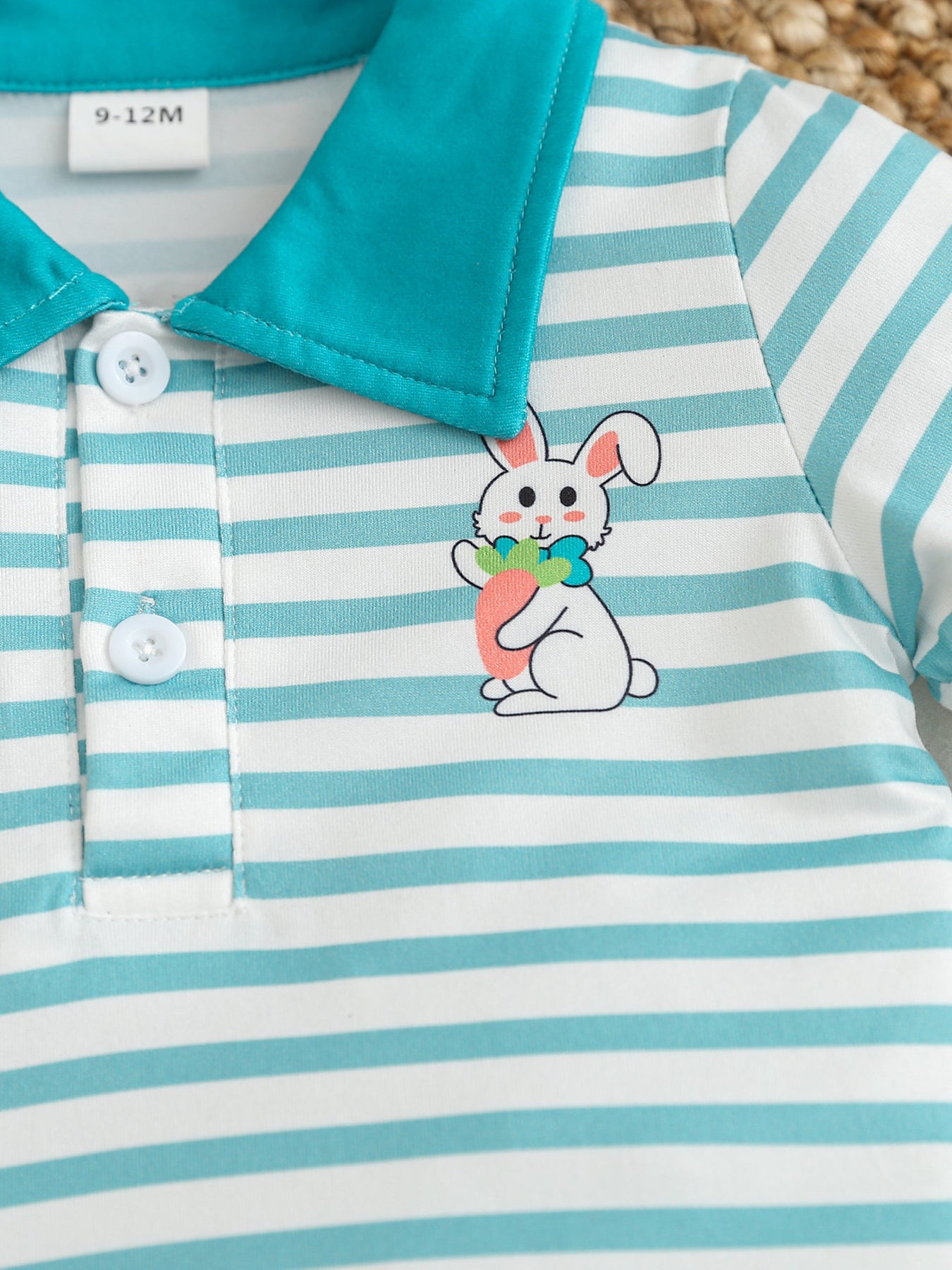 Children's striped polo shirt with bunny graphic and turquoise collar.
