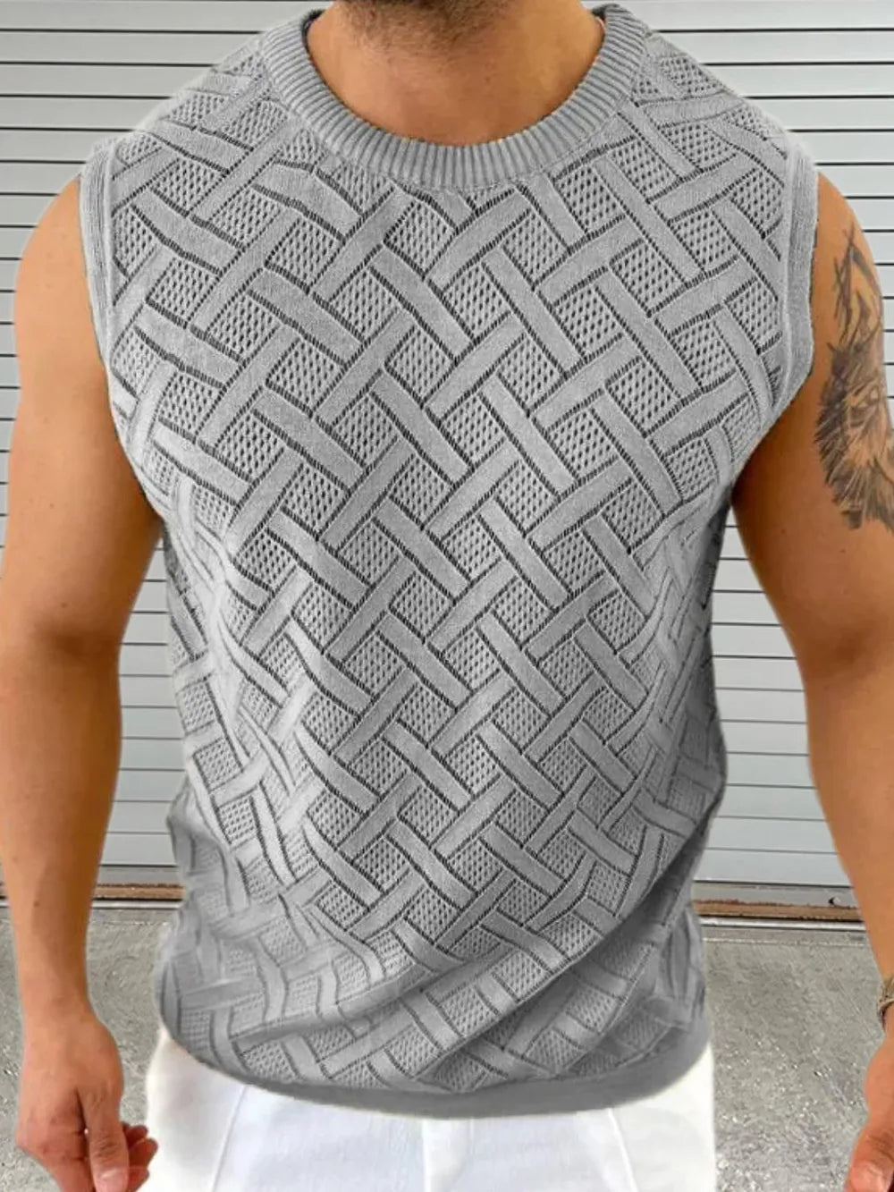 Gray knit sleeveless sweater with a geometric pattern and crew neck.