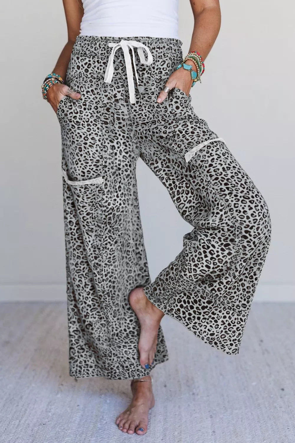 Animal print wide leg pants with drawstring waist and pockets.