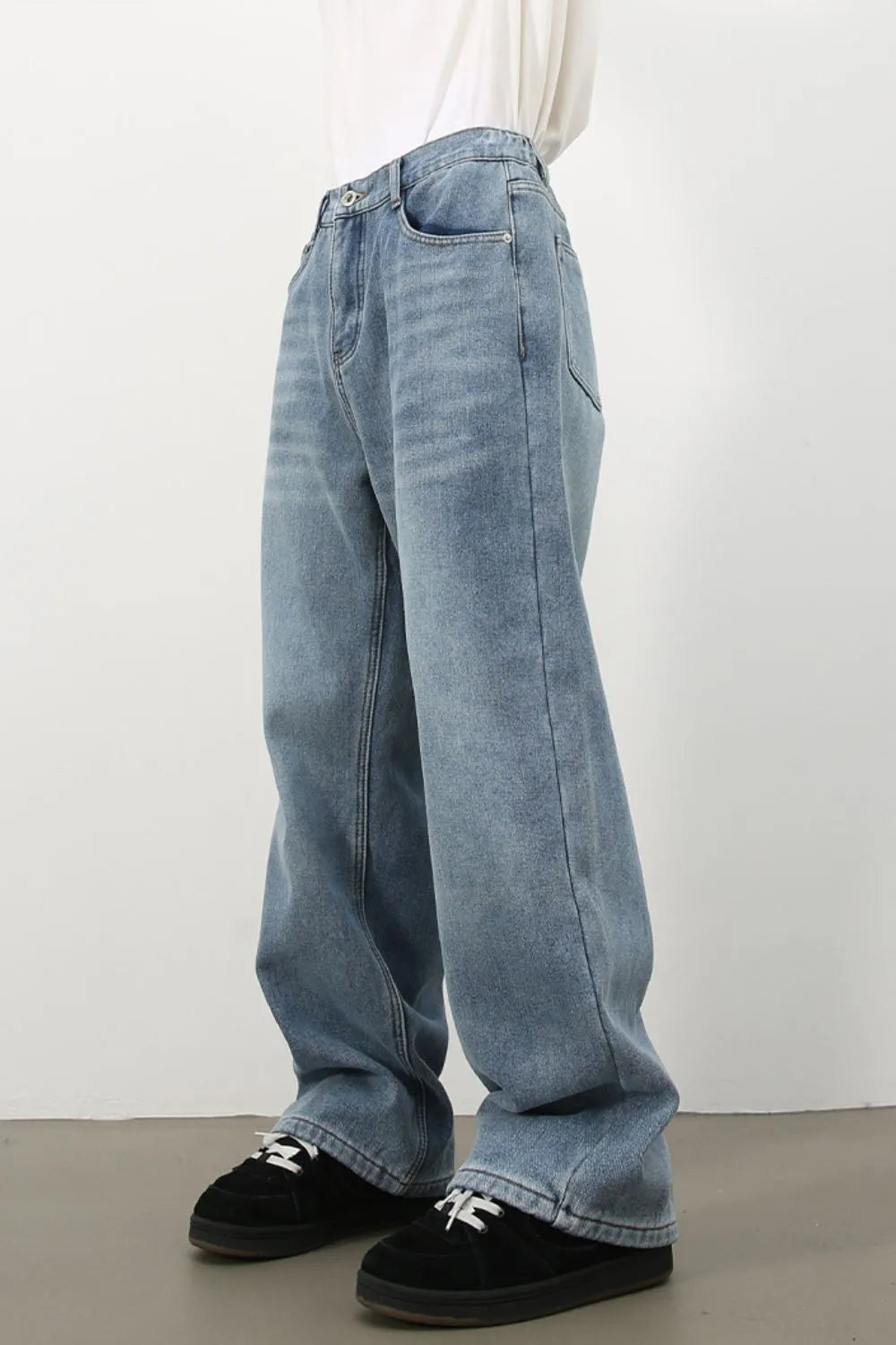 Oversized fade wash denim jeans in medium blue, relaxed fit, casual style.