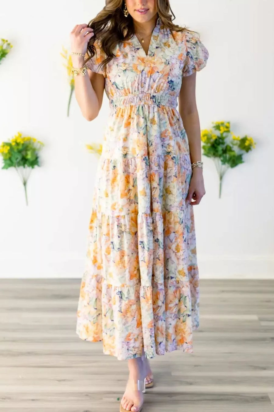 Vibrant floral smocked maxi dress with tiered skirt and short puff sleeves.