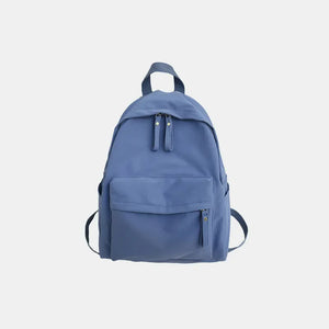 Dusty blue canvas school backpack with dual front pockets and zipper closures.