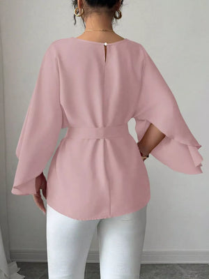 Pink belted blouse with batwing sleeves and button back detail.