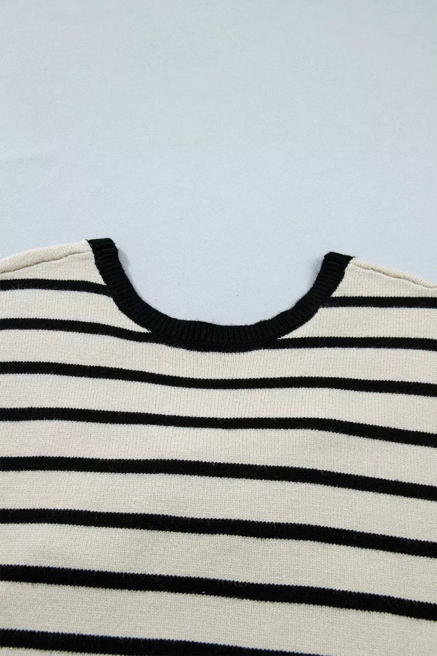 Chic stripe knit top with black trim neckline and black horizontal stripes.