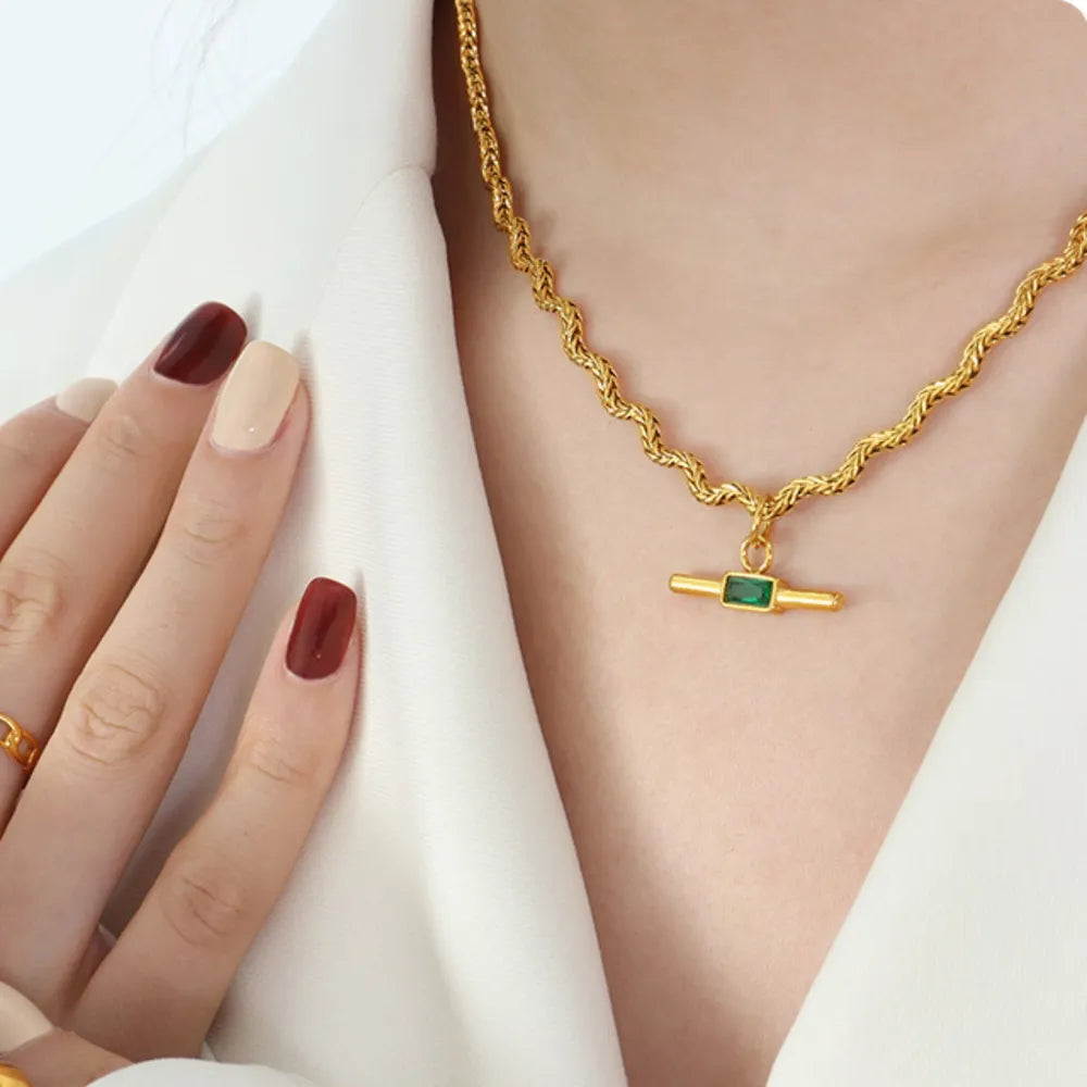 Gold rope chain necklace with emerald bar pendant