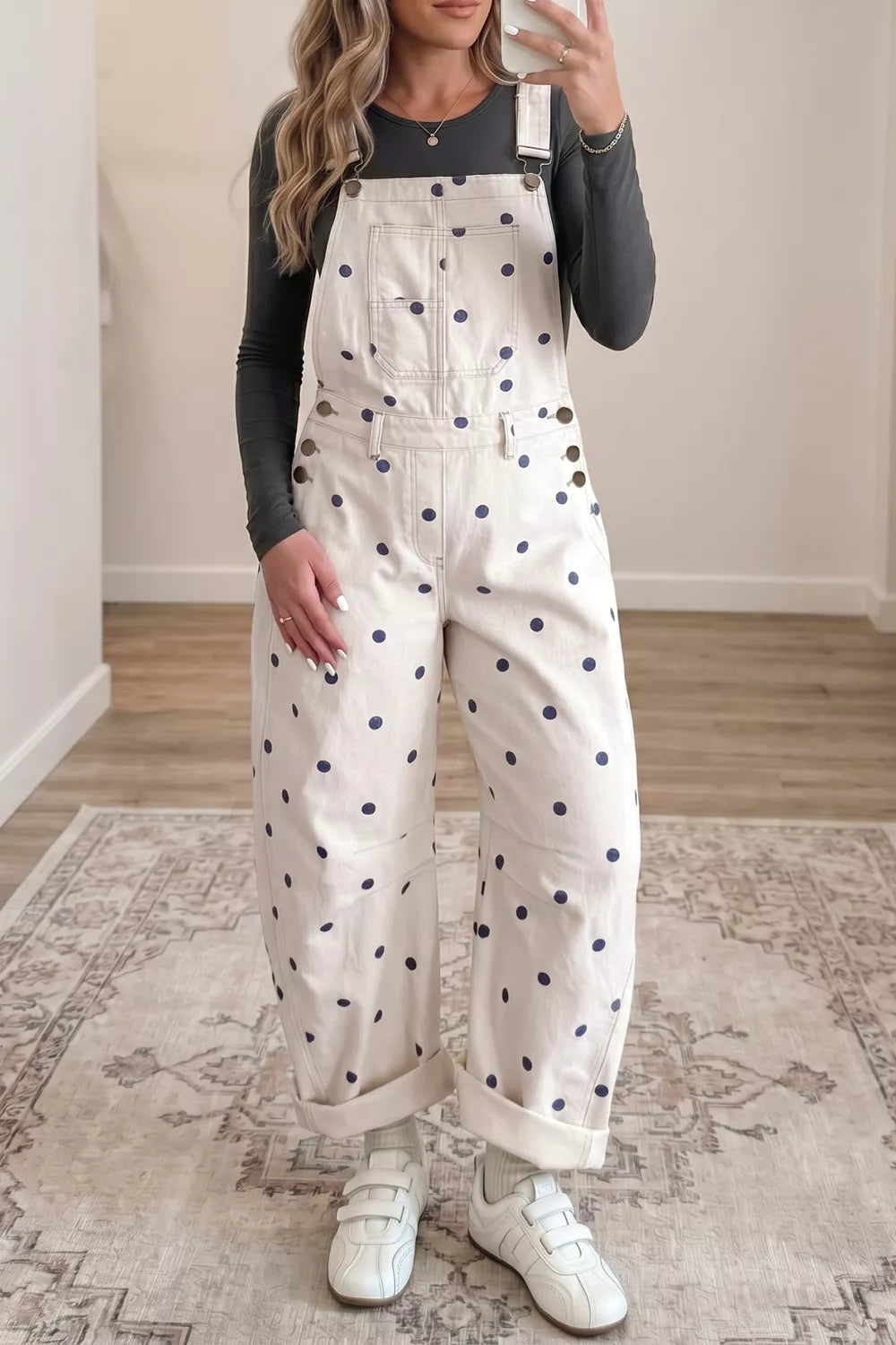 Denim overalls with navy polka dots and button accents.