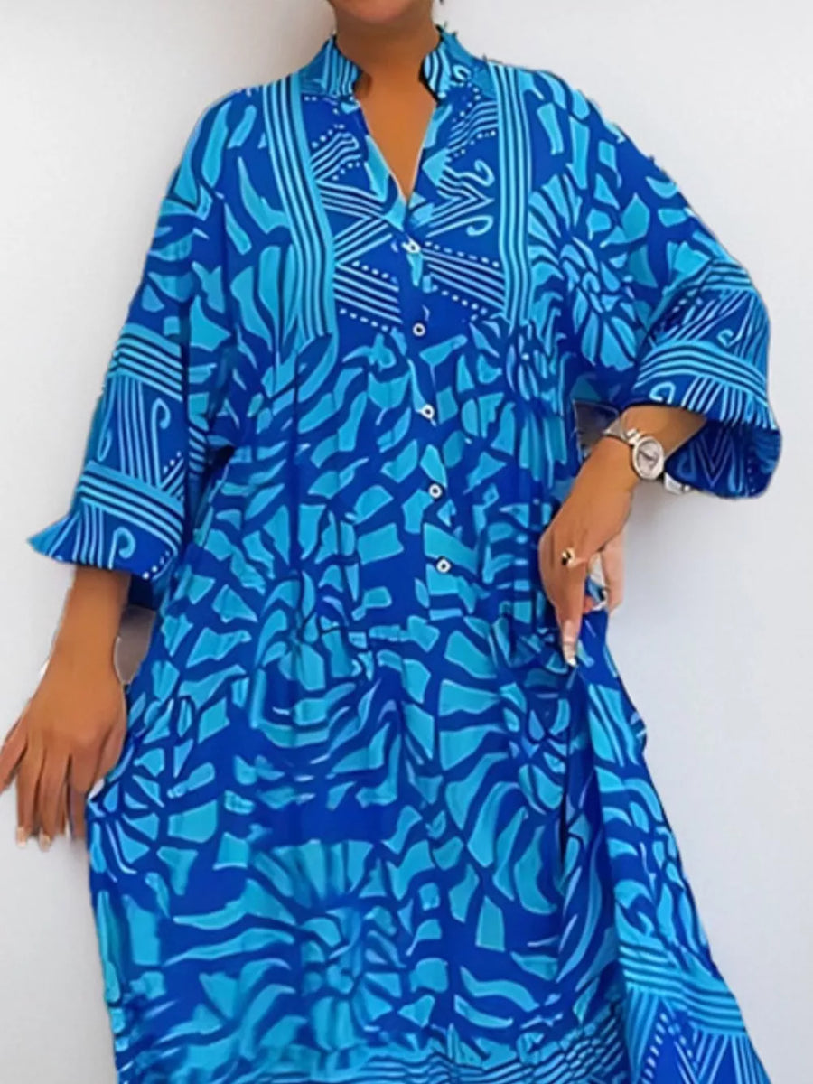 Vibrant abstract print midi dress in sky blue with a V-neck and button front.